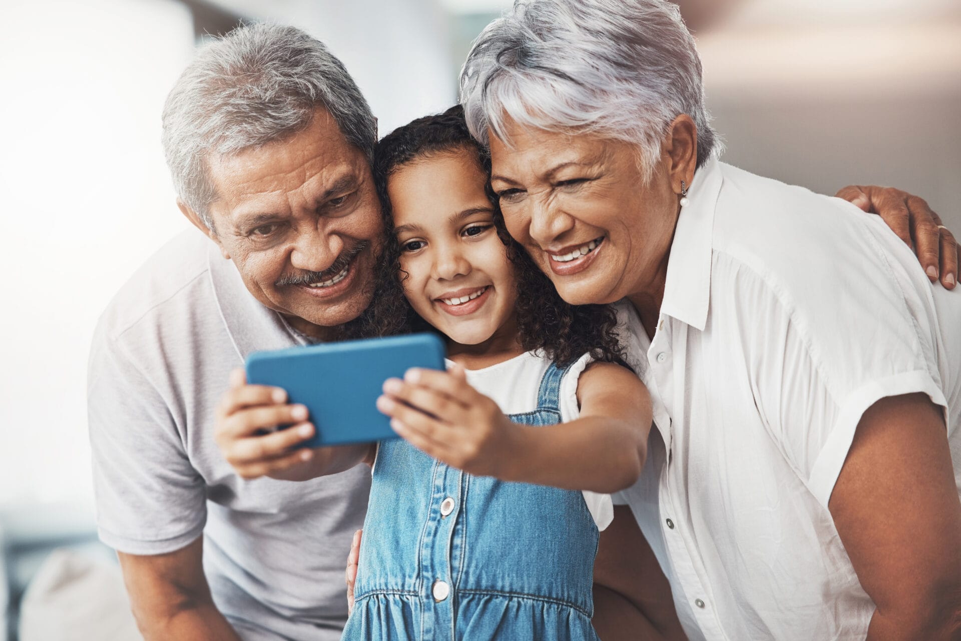 Love, happy and girl taking selfie with her grandparents for social media in modern family home. Happiness, smile and excited child taking picture with grandmother and grandfather at house in Mexico.